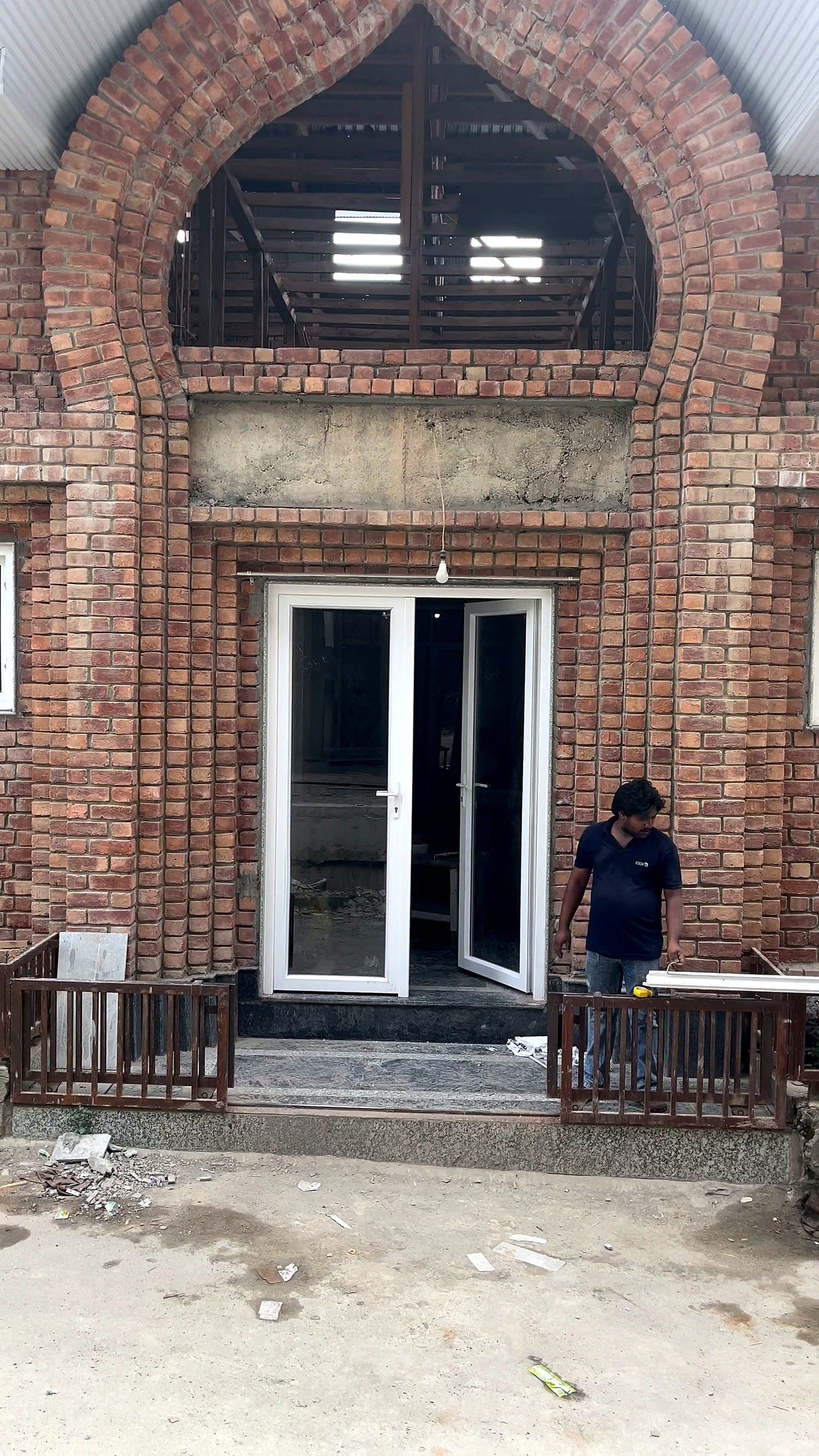 Kashmiri brick front with a traditional arch above new uPVC French doors