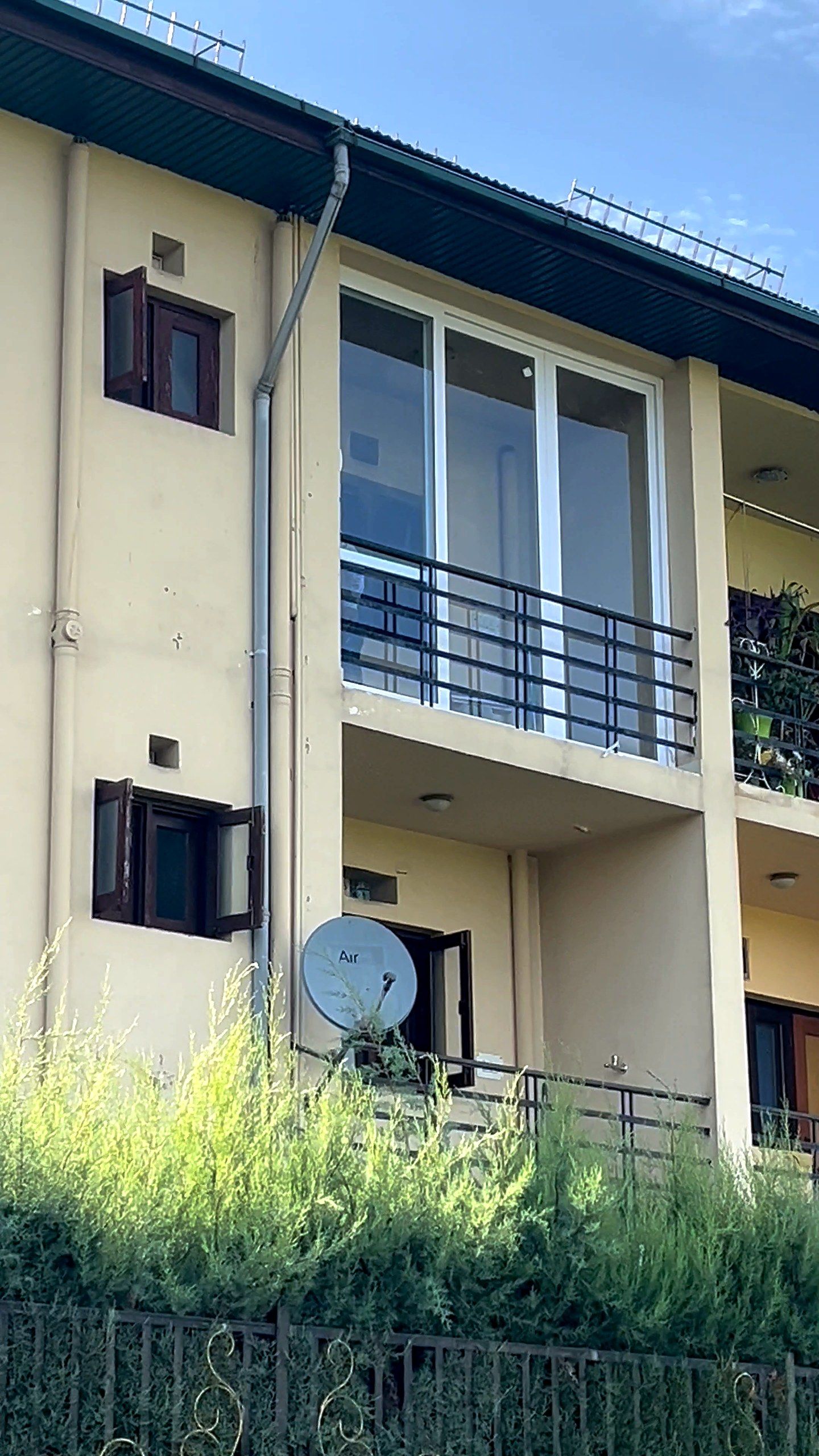 Three-storey house with balcony doors and windows