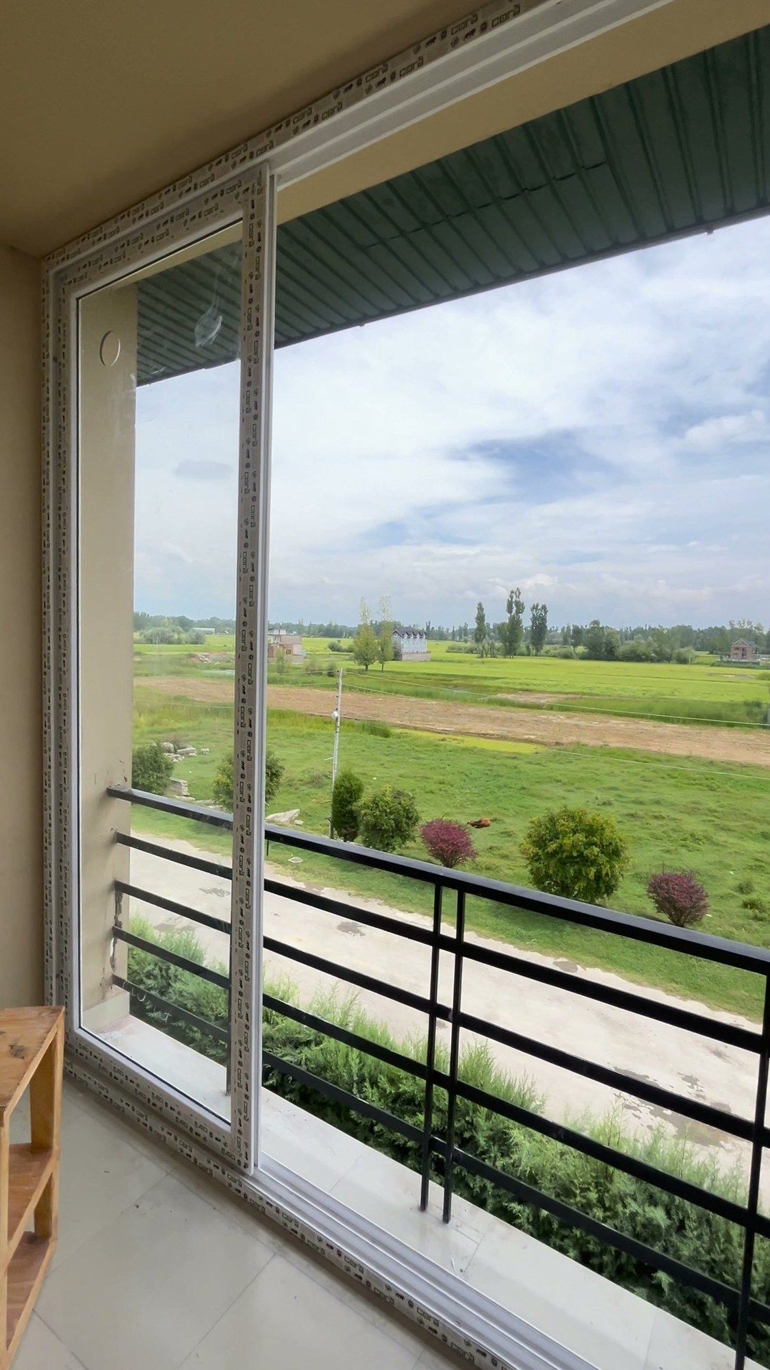 Sliding door onto a balcony with a rural view