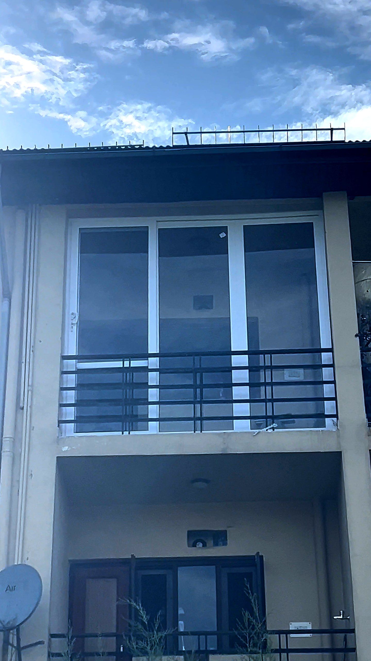 House with tall uPVC balcony doors and windows