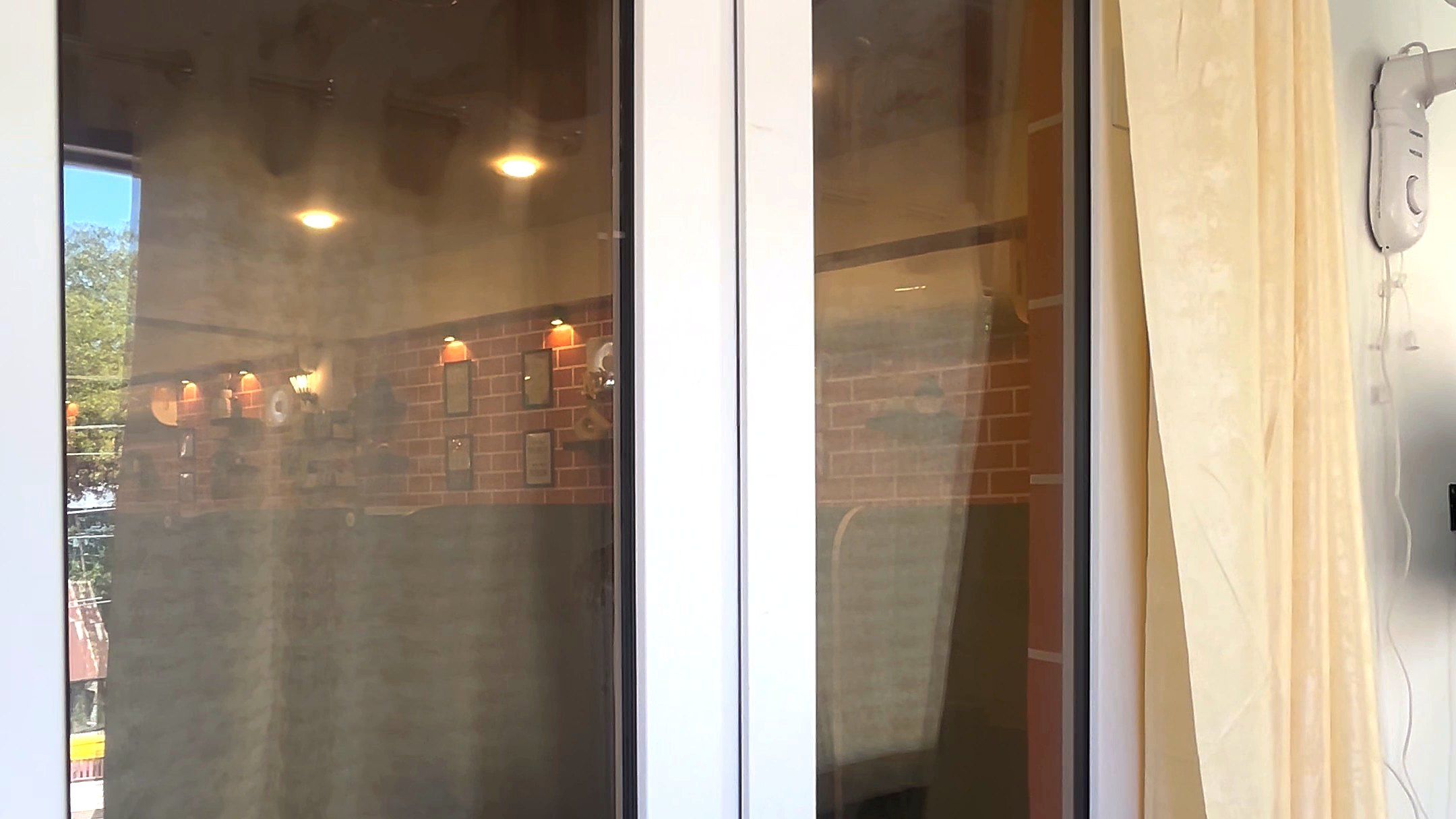 White uPVC windows beside a cream curtain inside a room
