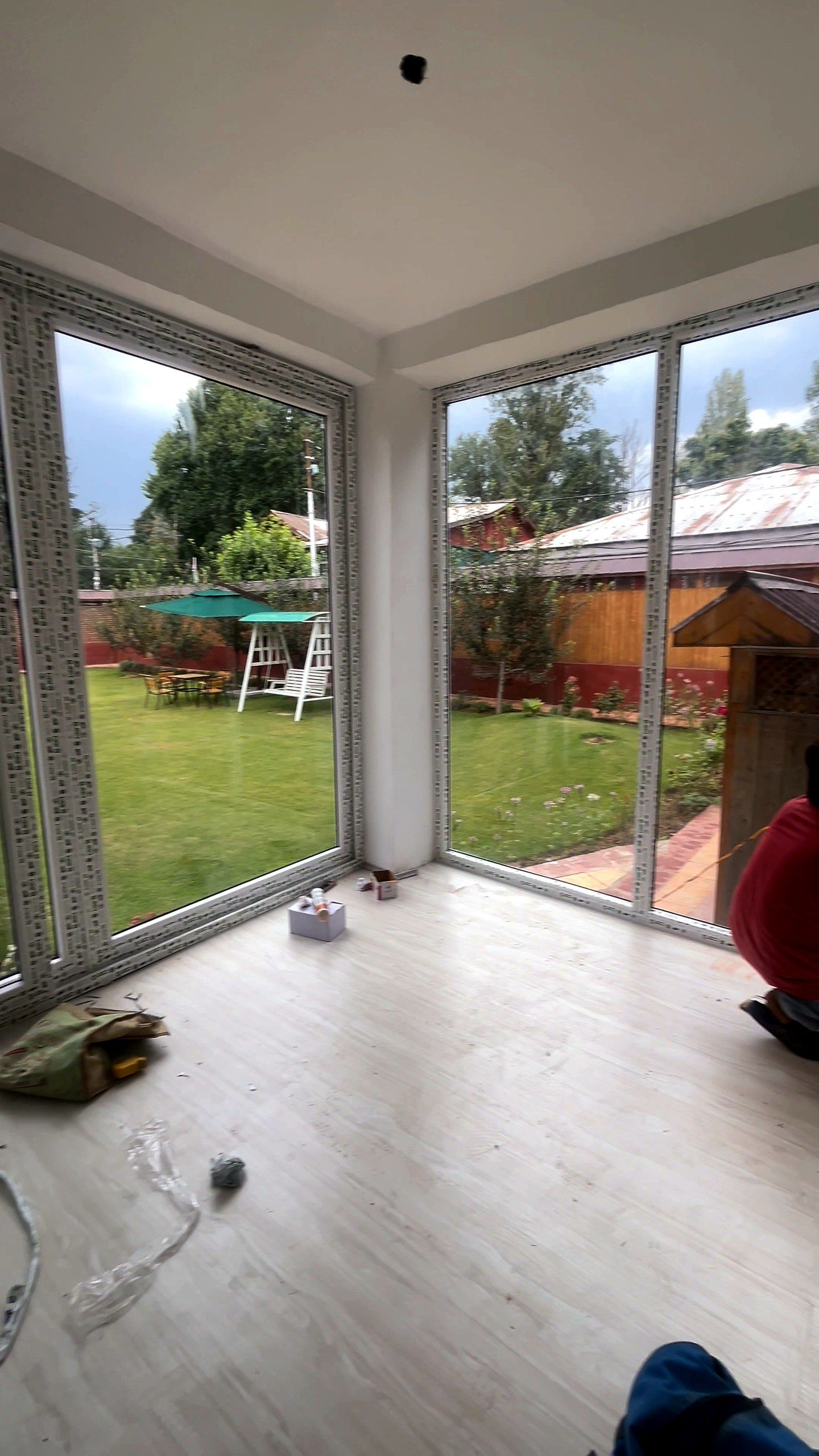 Glass corner looking onto a lawn and garden