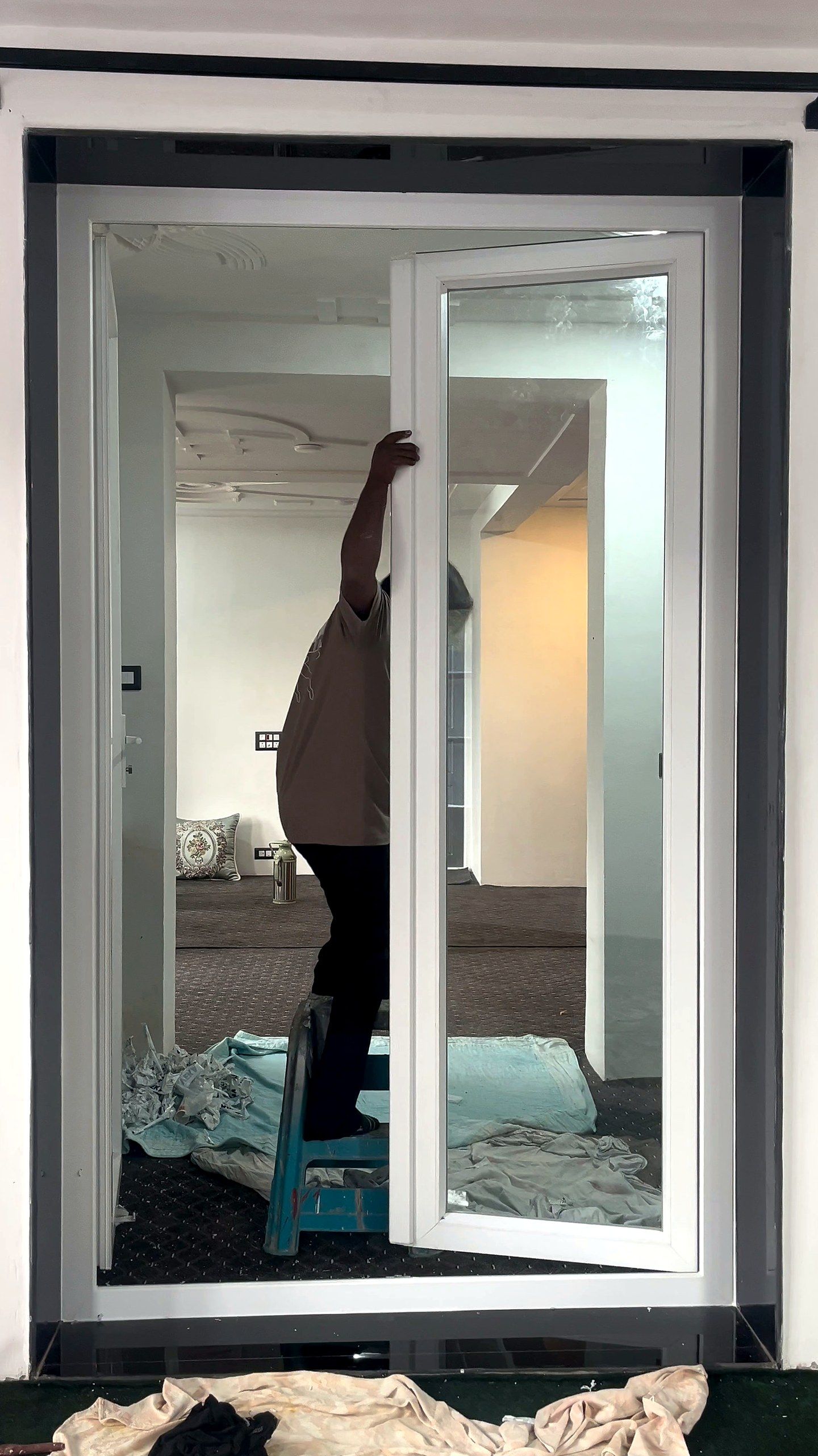 Fitter adjusting the top of a French door
