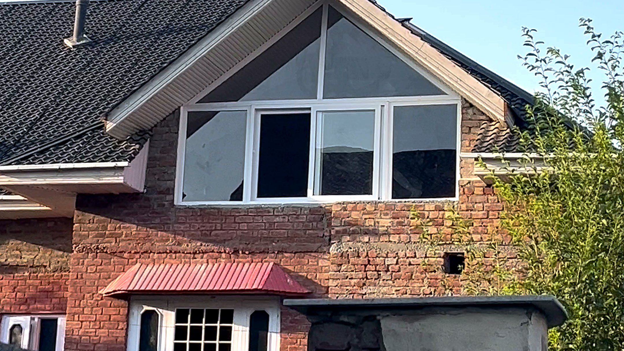 A Kashmir house with large uPVC gable windows fitted by Standard Fabtech