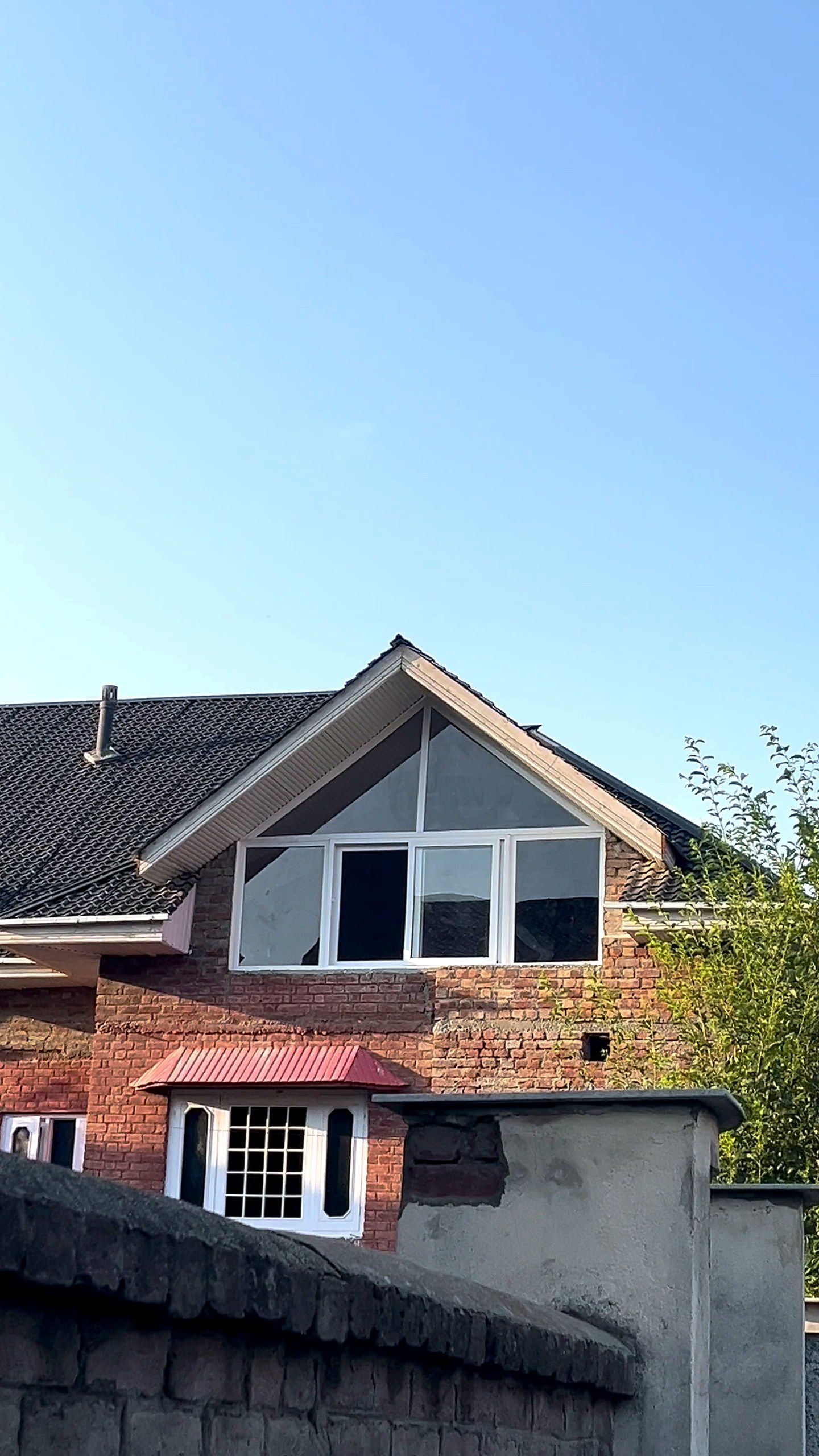 A Kashmir house fitted with large uPVC gable windows