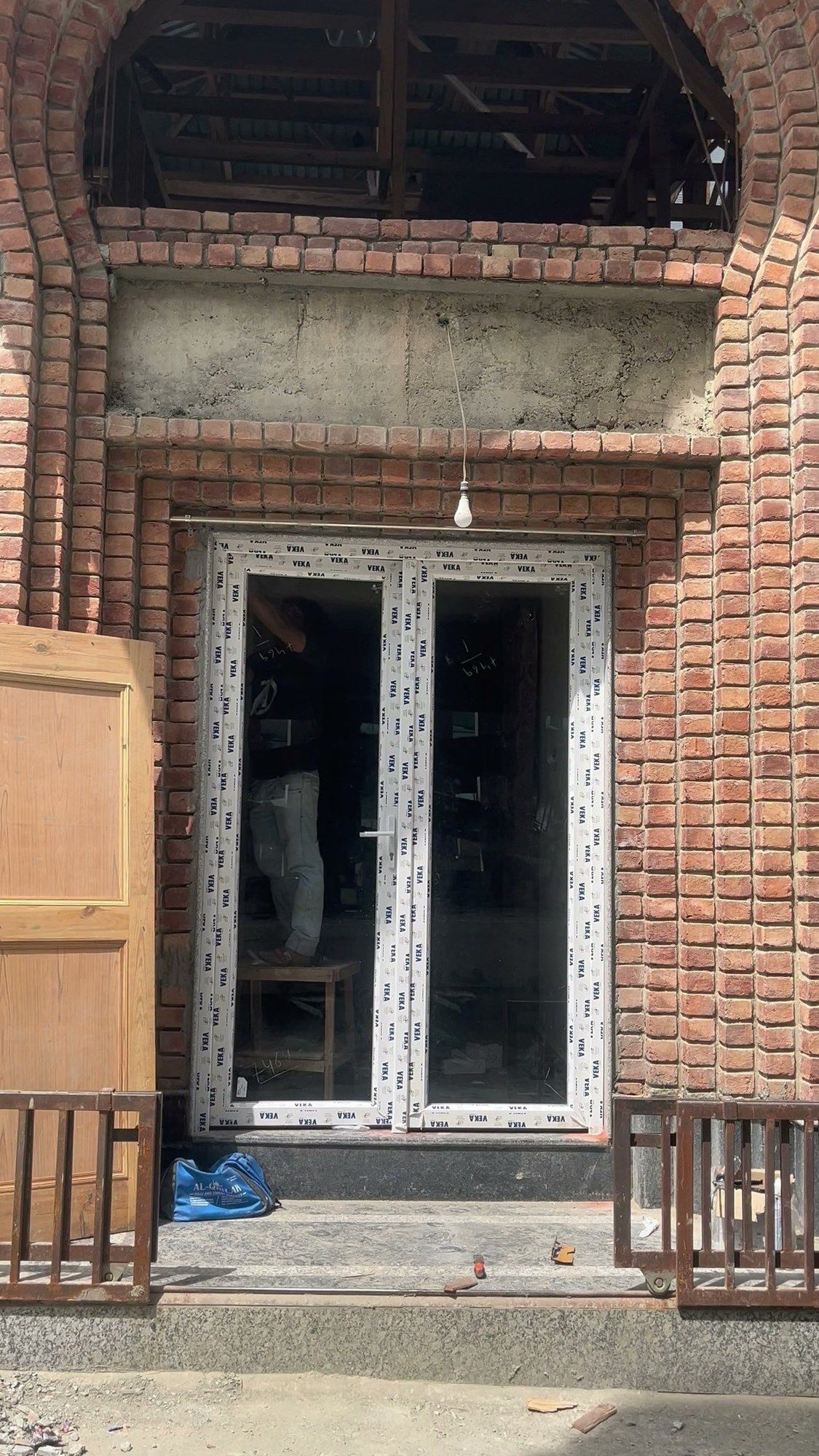 Old arched brick opening with new doors