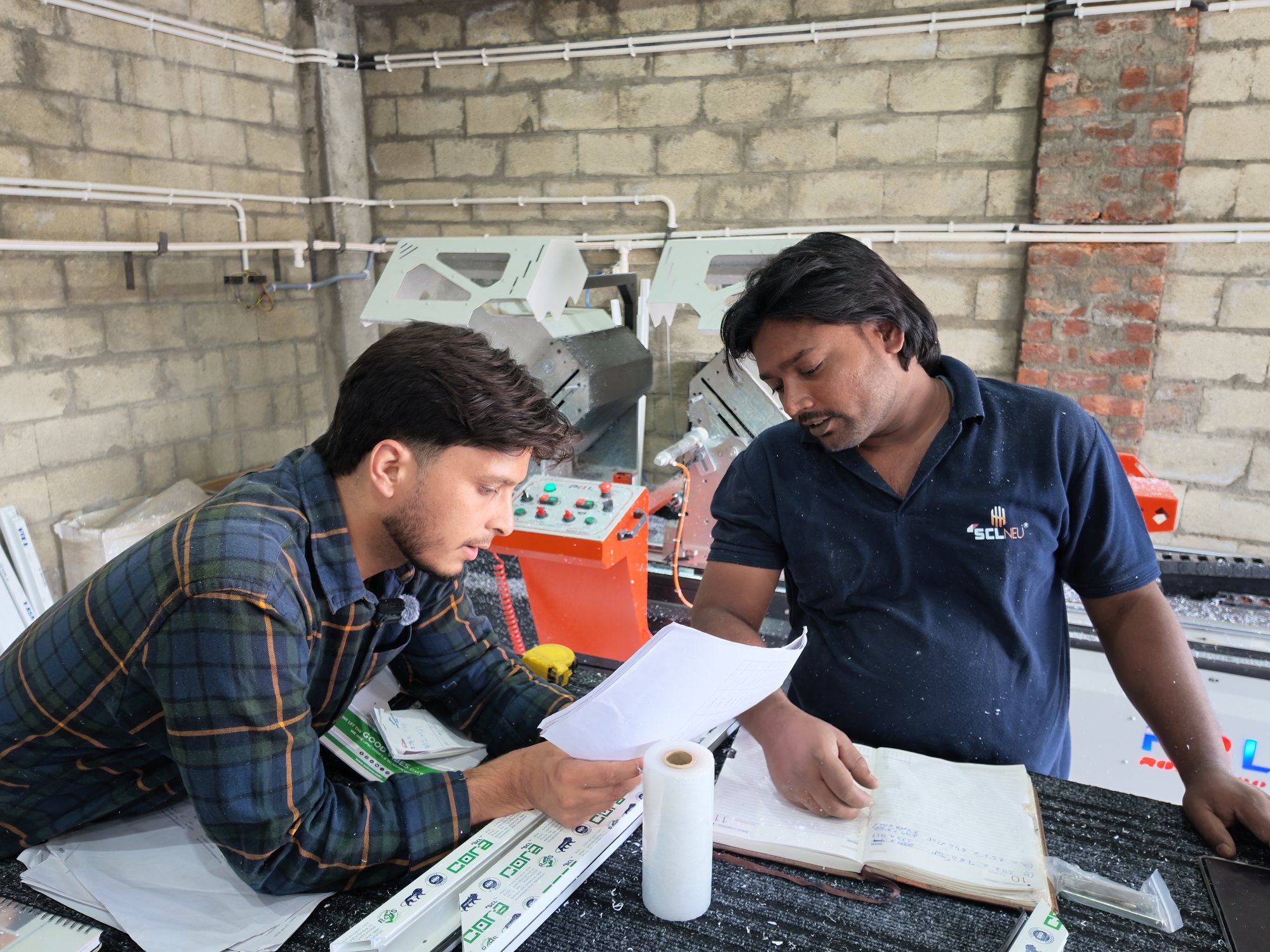 Standard Fabtech team going over window drawings and a quotation in the plant