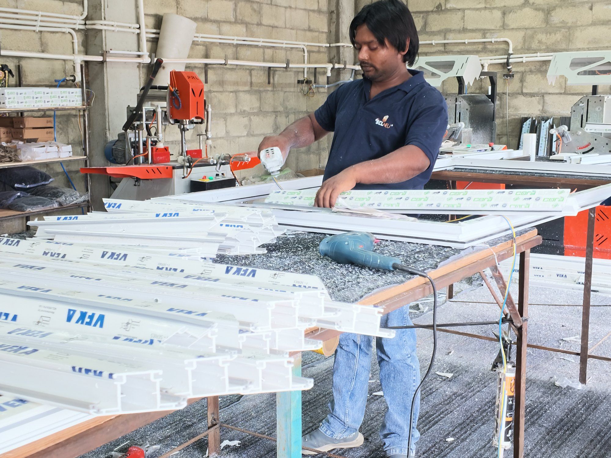 Finished VEKA uPVC frames on the assembly table in the plant