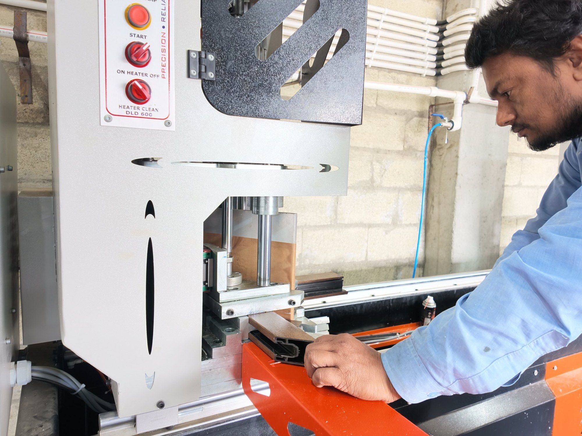 Operator machining a VEKA profile in the Standard Fabtech plant