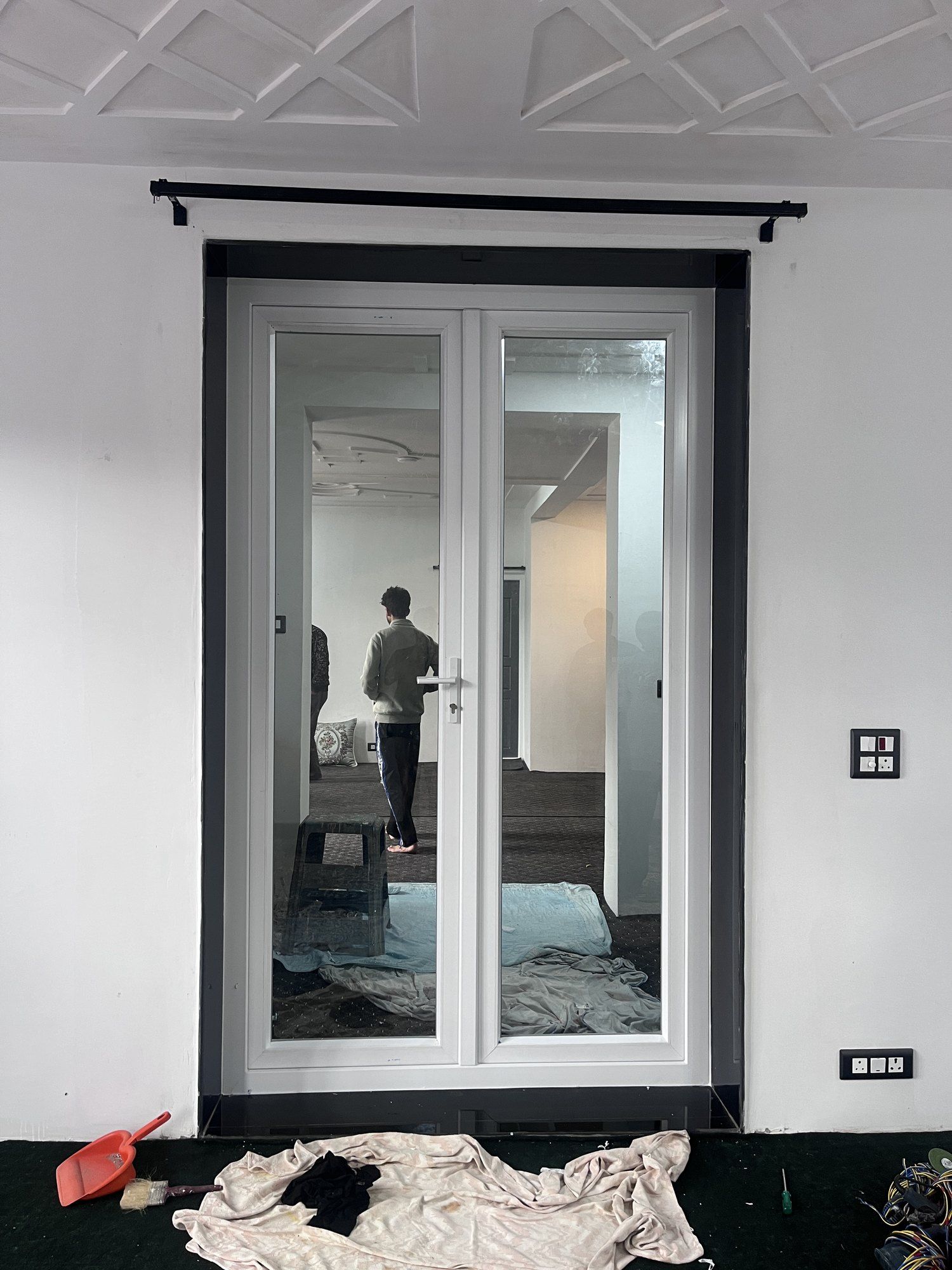 Newly fitted French doors in a plastered room