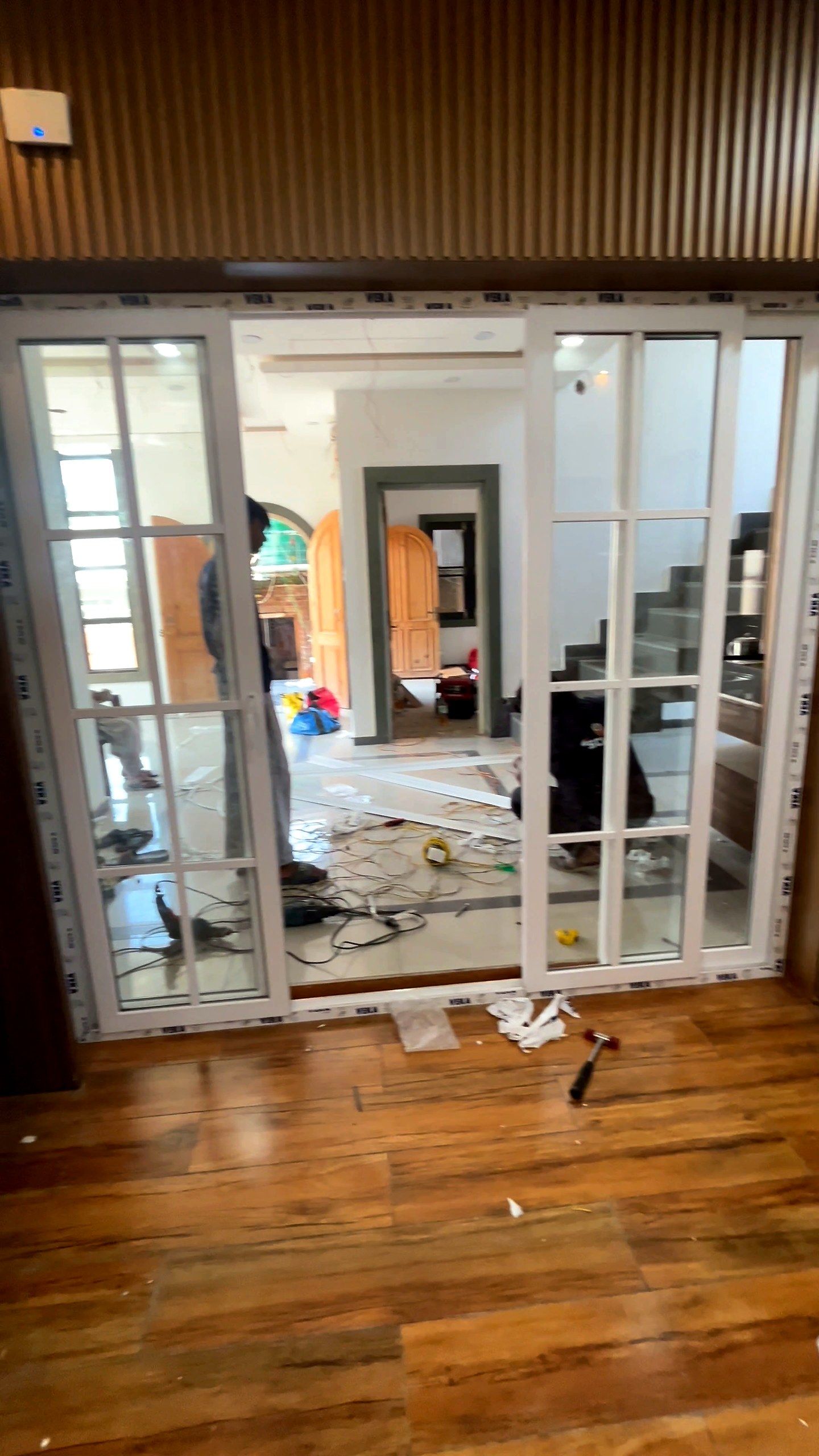Glazed sliding doors in a room with wooden floors