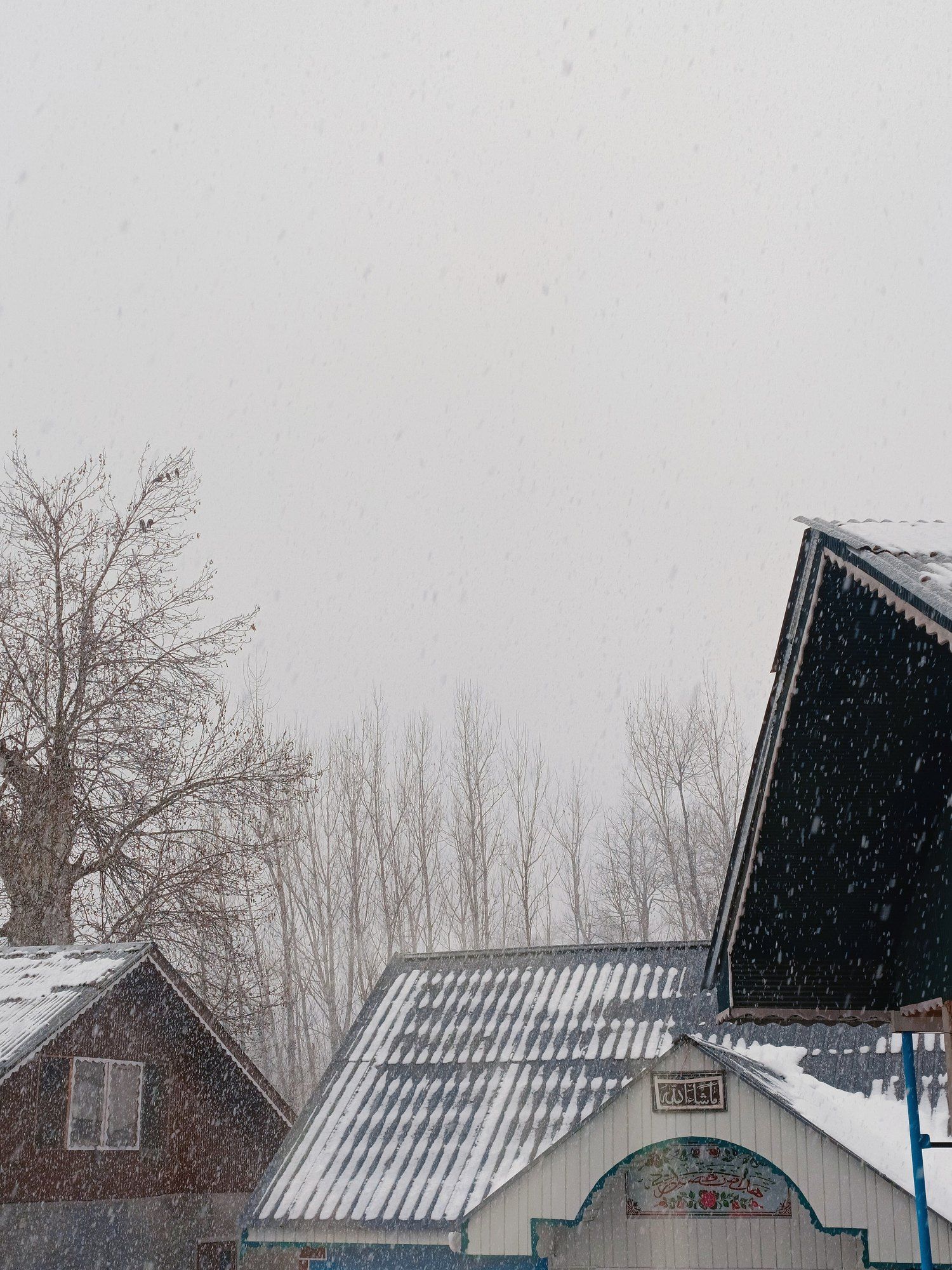 Snow on the roofs of houses in Kashmir