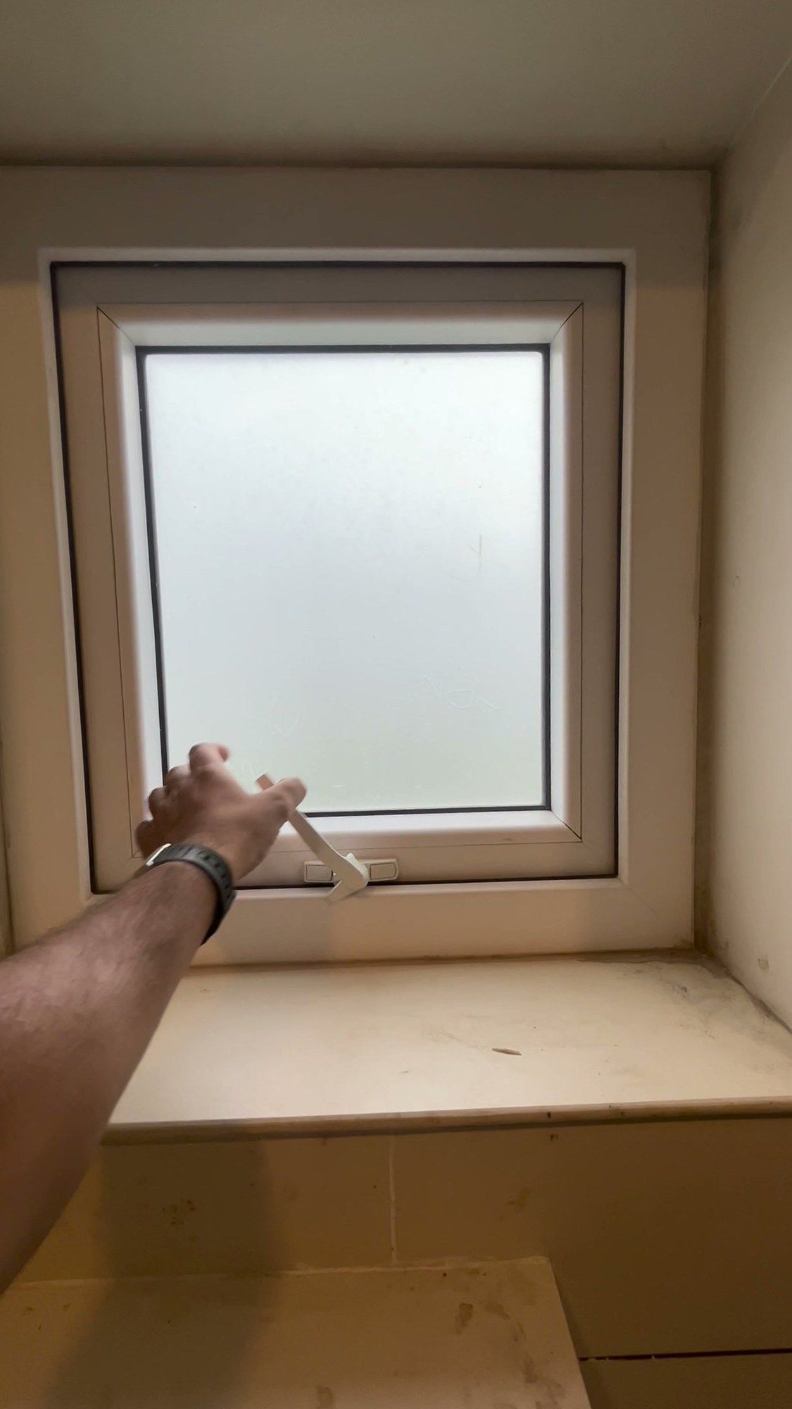 Opening a newly fitted top-hung window by its handle
