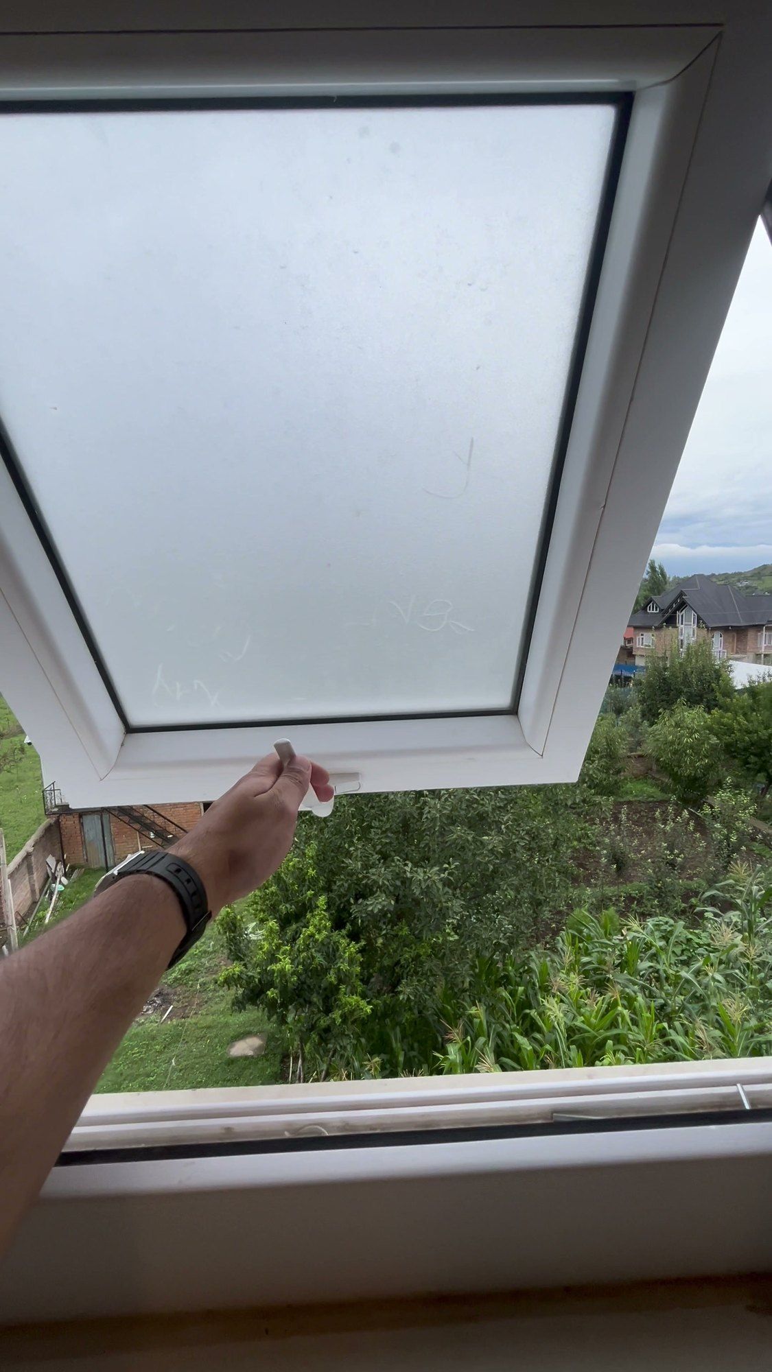 Top-hung window with frosted glass opened outward