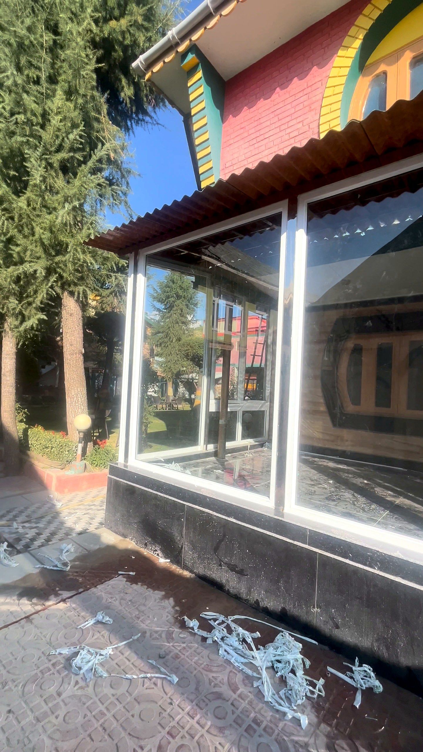 Glazed veranda with large uPVC panels on a colourful Kashmiri house