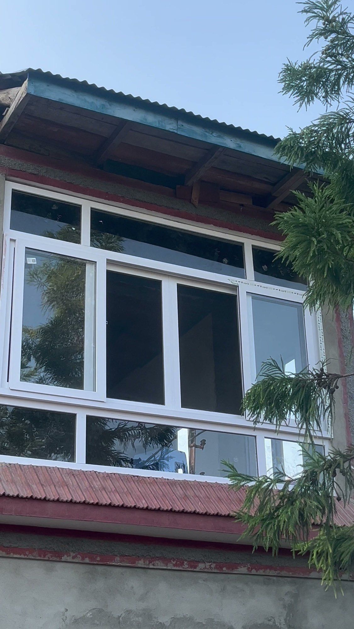 White uPVC windows on a house with a red roof