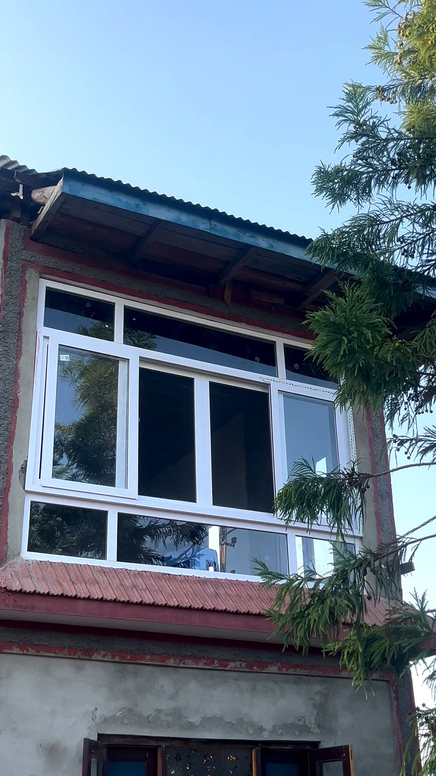 White uPVC window combinations across the upper floor of a house