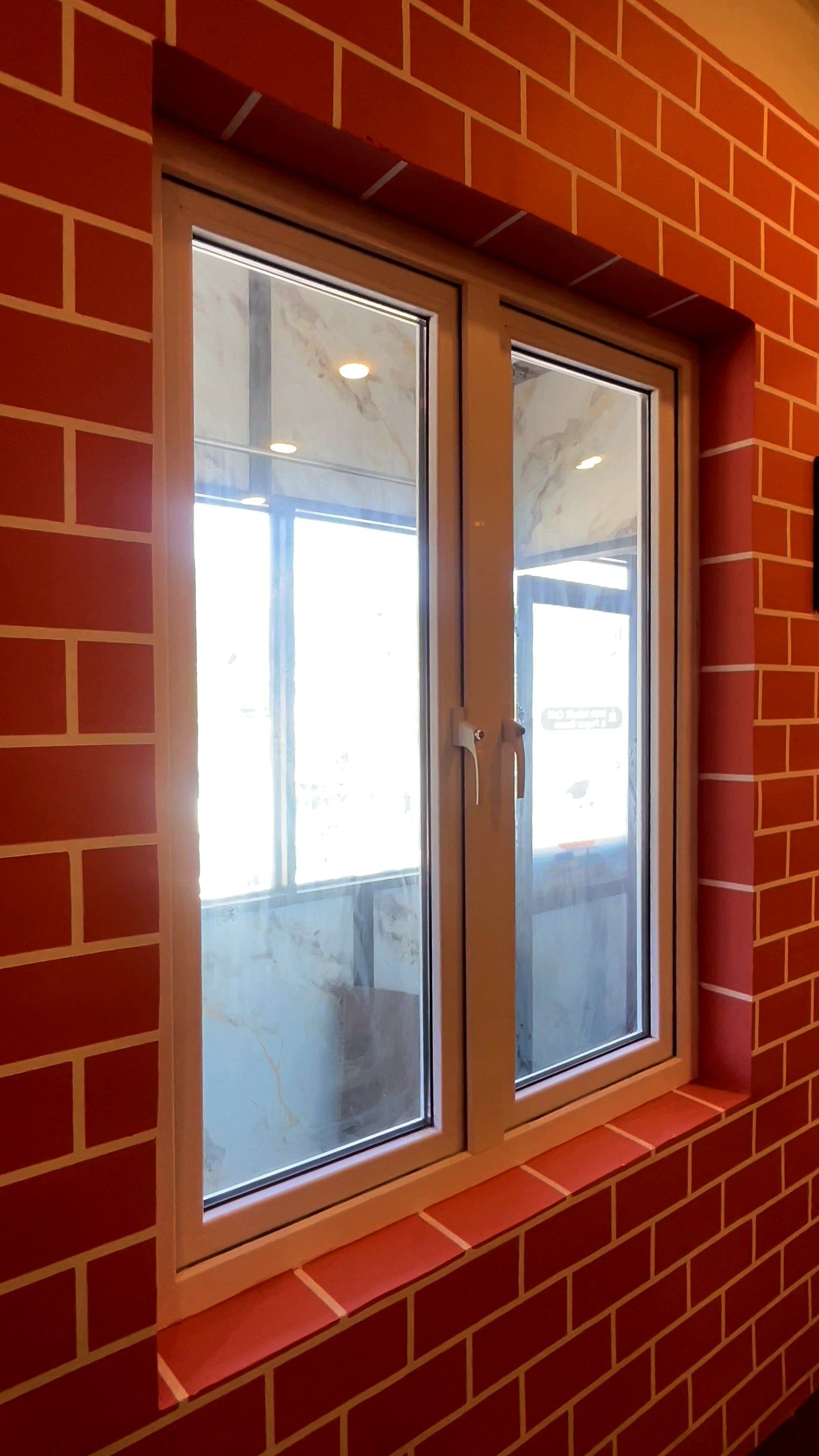 Golden oak woodgrain uPVC casement windows in a brick-finish room